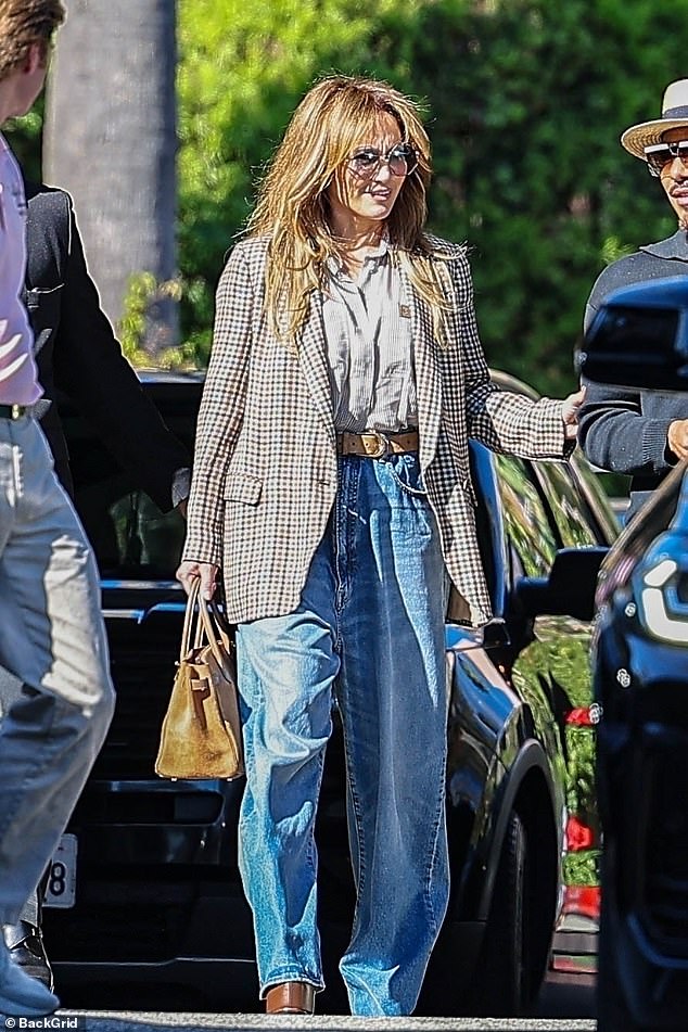 The Hustlers star rocked a chic blazer over a striped button-up tucked into a pair of oversized blue jeans